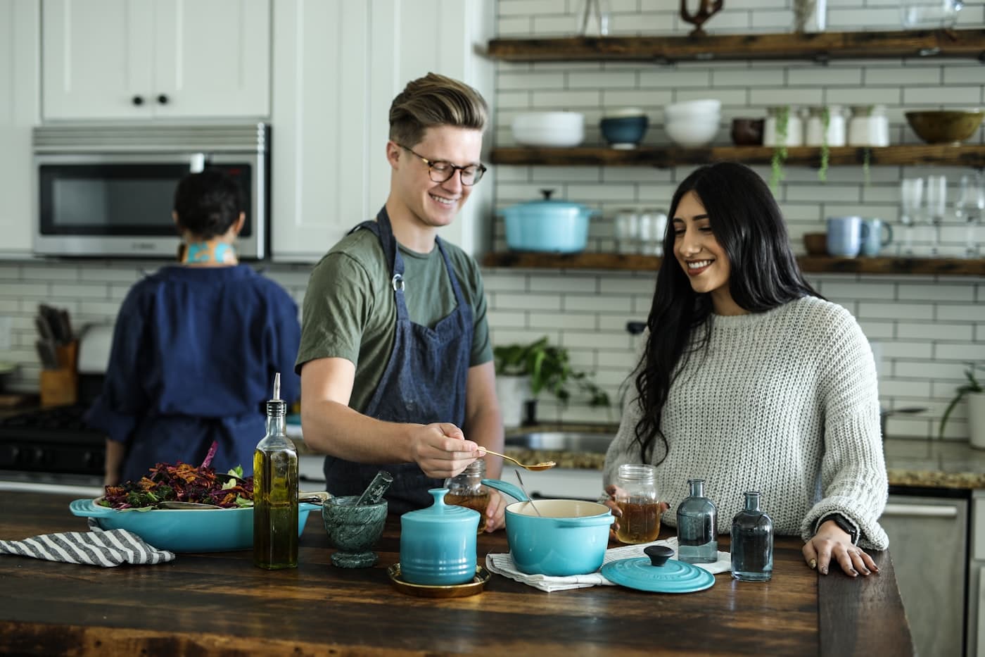 A couple at home together, preparing food in a bright kitchen